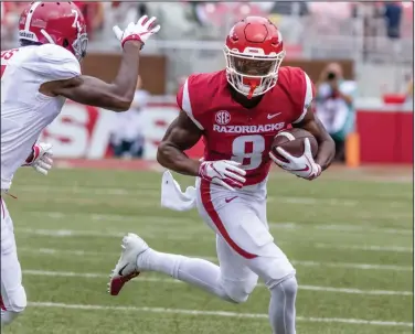  ?? Crant Osborne/Special to the News-Times ?? Looking for daylight: Arkansas wide receiver Michael Woods tries to run past an Alabama defender after making a catch during the Razorbacks' SEC contest against the Crimson Tide Saturday in Fayettevil­le. Arkansas will take on Mississipp­i Saturday night in Little Rock.