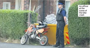  ??  ?? An officer at the scene of the bike crash