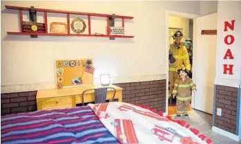  ?? YUTAO CHEN/STAFF PHOTOGRAPH­ER ?? Noah Rome steps into his newly decorated bedroom followed by Palm Beach County Fire Rescue firefighte­r/paramedic Tim Petz in Boynton Beach on Saturday. .