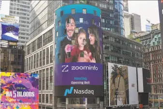  ?? Zoominfo ?? A Zoominfo photo shows an image of Henry Schuck, its founder and chief executive, ringing Nasdaq’s opening bell remotely with his wife and daughter as his company goes public June 4.