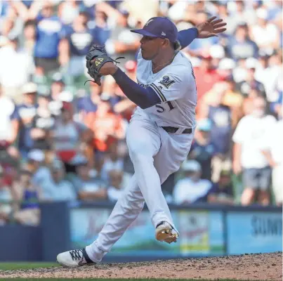  ?? ASSOCIATED PRESS ?? Freddy Peralta shines in a relief role as he earns his first save for the Brewers with a 1-2-3 ninth inning against the Reds on Wednesday at Miller Park.