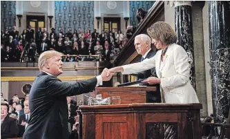  ?? DOUG MILLS THE NEW YORK TIMES ?? President Donald Trump shakes hands with House Speaker Nancy Pelosi (D-Calif.) before his State of the Union address, at the Capitol in Washington, Tuesday night. Looking on is Vice President Mike Pence.