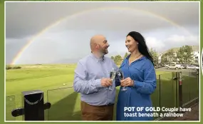  ?? ?? POT OF GOLD Couple have toast beneath a rainbow