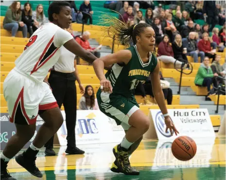  ?? CITIZEN FILE PHOTO ?? UNBC Timberwolv­es forward Maria Mongomo drives to the net around University of Winnipeg Wesmen defender Faith Hezekiah on Nov. 3, 2018 at the Northern Sport Centre.