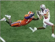  ?? BUTCH DILL — THE ASSOCIATED PRESS ?? Ohio State wide receiver Chris Olave catches a touchdown pass in front of Clemson cornerback Derion Kendrick during the game Friday, in New Orleans.