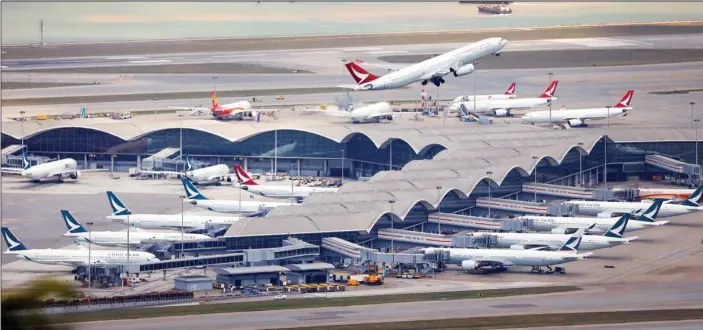  ?? EDMOND TANG / CHINA DAILY ?? Cathay Dragon fleet sits parked on the tarmac at Hong Kong Internatio­nal Airport.