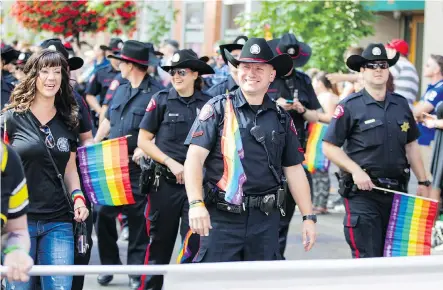  ?? ADRIAN SHELLARD/FILES ?? The Calgary Police Service members marched in the 2014 Calgary Pride. An expert defended the organizers’ decision to not allow uniformed officers to march in this year’s event. Mayor Naheed Nenshi is among those who are disappoint­ed with the decision.
