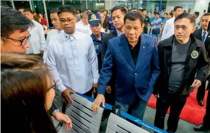  ??  ?? Philippine President Rodrigo Duterte at the Davao Internatio­nal Airport terminal after arrving back from a state visit to Brunei and China. —