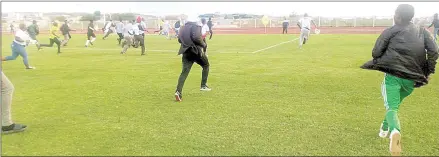  ?? (Pic: Ashmond Nzima) ?? Fans run after referee Mbongeni Shongwe after a Premier League game between Manzini Sea Birds and Mbabane Highlander­s, at Mavuso Sports Centre on Sunday.