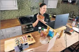  ?? CHRIS SWEDA/CHICAGO TRIBUNE ?? Chopping Block executive chef Lisa Counts teaches a virtual sushi making class Thursday at the Lincoln Square store. The cooking school is offering online classes amid the pandemic.