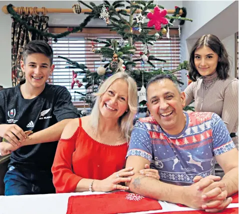  ??  ?? Mal Martin, pictured with his wife, Sue, and children Wiliam and Hana before his illness, lost his sight in one eye, had to have fingers amputated and has permanent kidney damage