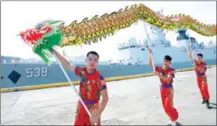  ?? TED ALJIBE/AFP ?? Dragon dancers perform as Chinese guided-missile frigate Wuhu prepares to dock at the internatio­nal port in Manila on January 17.