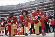  ?? MARCIO JOSE SANCHEZ — THE ASSOCIATED PRESS ?? 49ers outside linebacker Eli Harold, quarterbac­k Colin Kaepernick and safety Eric Reid kneel during the national anthem before a 2016 game in Santa Clara, Calif.