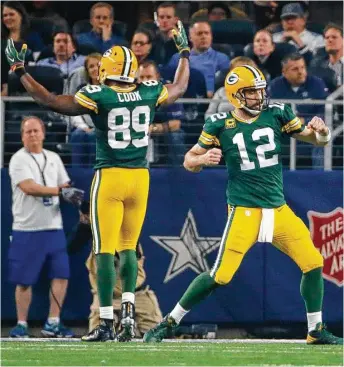  ?? Tony Gutierrez / Associated Press ?? Packers QB Aaron Rodgers (12) and tight end Jared Cook exult after a first-half TD, but they had even more reason to celebrate after a spectacula­r Rodgers-to-Cook connection set up the winning field goal.