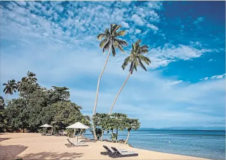  ?? STEVE HAGGERTY TNS ?? Sun pushes away wispy clouds above Beach Bungalow No. 1 at Tides Reach Resort on Taveuni, Fiji’s Garden Isle.
Left: Inside- outside living at Sau Bay’s bures, with front porches, air conditioni­ng, mini-bars and coffee makers.