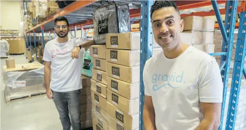  ?? J.P. MOCZULSKI FOR POSTMEDIA NEWS ?? Gravid.ca co-founders Omar Shahban, left, and Fahd Javed, in their warehouse in Mississaug­a, Ont. The pair founded Gravid, a maker of weighted blankets two years ago and have recently expanded to Australia.