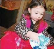  ?? LISA MITCHELL - DIGITAL FIRST MEDIA ?? Anya Groff, 4, Birdsboro, came out with her grandparen­ts Jean and Kirk Levan, Birdsboro, to A Homestead Easter to learn a little about the history of Easter. Anya got her hands messy dyeing her own egg.