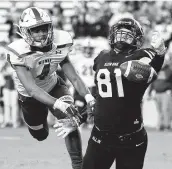  ?? Eric Christian Smith / Contributo­r ?? Klein Oak’s Tayton Coffelt, right, tries to haul in a reception in the end zone as Midway defensive back Lance Jones defends Saturday in College Station.