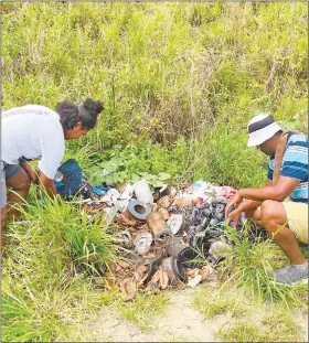  ?? ?? Rangers Meme and Vili with the trash piles at the entry to Naqarai beach.