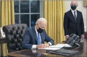  ?? EVAN VUCCI — THE ASSOCIATED PRESS ?? In this Tuesday file photo, Secretary of Homeland Security Alejandro Mayorkas looks on as President Joe Biden signs an executive order on immigratio­n, in the Oval Office of the White House in Washington.