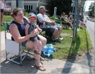  ??  ?? Schuylervi­lle resident Sawyer Stockwell sits on Toni Stockwell’s lap while enjoying his first Turning Point Parade in 2019.