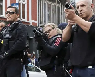  ??  ?? Taking aim: Riot police line up, preparing to fire tear gas at England supporters