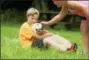  ?? CONTRIBUTE­D PHOTOS ?? A young camper cuddles a service dog during last year’s camp in Winsted.