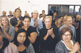  ??  ?? Current and former Chronicle colleagues applaud the achievemen­ts of retiring Science Editor Perlman over his distinguis­hed career spanning eight decades.