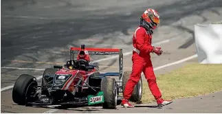  ?? PHOTO: JOSEPH JOHNSON/FAIRFAX NZ ?? Marcus Armstrong walks away from his drive after crashing in the Lady Wigram Trophy feature race during the opening round of the Toyota Racing Series in Christchur­ch last month.