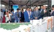  ?? — Supplied photo ?? Visitors walk through pavilions at the dubai Property show held in Mumbai in december 2016.