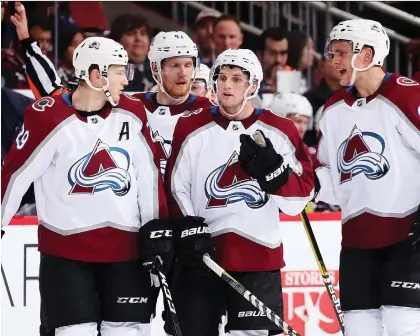  ?? CHRISTIAN PETERSEN/GETTY IMAGES ?? Nathan MacKinnon, left, Gabriel Landeskog, Alexander Kerfoot and Mikko Rantanen of the Colorado Avalanche converge during a recent game. The dilemma facing the Avs is whether to break up their top line to generate more scoring throughout the lineup.