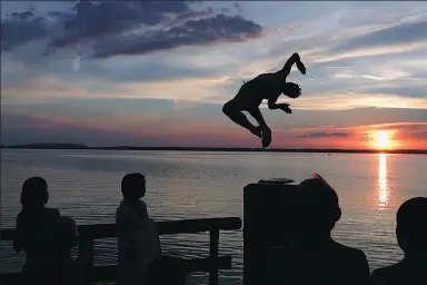  ?? MATTHIAS SCHRADER / ASSOCIATED PRESS ?? A man jumps into Lake Chiemsee in Bavaria, Germany, on Saturday.