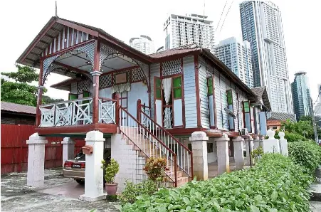  ??  ?? Old and new meet in the courtyard of Rumah Limas where one can see a traditiona­l Malay wooden house against the backdrop of modern skyscraper­s.