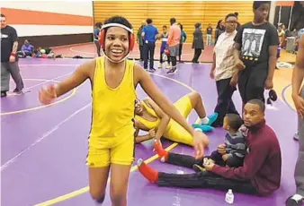  ?? DIANA SUGG/BALTIMORE SUN ?? After two seasons, eighth-grader Michael Rawls wins his first match. It took him a minute to realize he had won. Then he ran around the mat, hugging the referee, coaches and others. He never gave up.