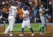  ?? MICHAEL WYKE — THE ASSOCIATED PRESS ?? The Houston Astros’ Michael Brantley (23) and Jose Altuve, middle, bump forearms next to Oakland Athletics catcher Sean Murphy, right, after Altuve’s home run during the seventh inning Thursday in Houston.