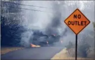  ?? MARCO GARCIA — THE ASSOCIATED PRESS ?? Lava crosses the road near Pohoiki Rd, Friday, near Pahoa, Hawaii.