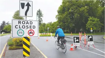  ?? MIKE BELL ?? A cyclist enters Stanley Park along Beach Ave. on Thursday. On April 8, the park board temporaril­y banned bicycles on the seawall and motor vehicles on Park Drive.