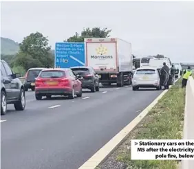  ??  ?? Stationary cars on the M5 after the electricit­y
pole fire, below