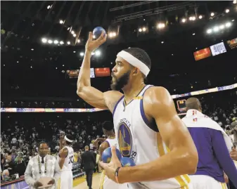  ?? Carlos Avila Gonzalez / The Chronicle ?? The Warriors’ JaVale McGee throws souvenir balls into the crowd after the regular-season finale at Oracle Arena, a 109-94 win over the Lakers for the Warriors 15th victory in 16 games.