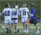  ?? PETE BANNAN — MEDIANEWS GROUP ?? Kennett’s Zack Hulme (19) is congratula­ted by Broc Fantazzi (12) after scoing in the first half as Downingtow­n East’s Dennis Brady (12) walks off.