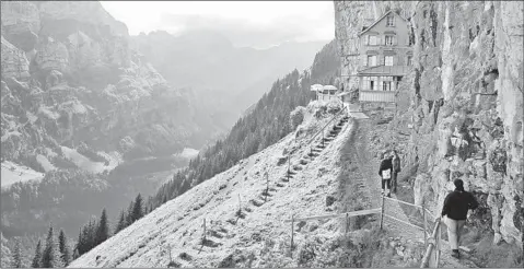  ?? CAMERON HEWITT PHOTO ?? High above the town of Appenzell, Switzerlan­d’s Ebenalp summit is home to a family-run hut with cheap dorm beds and a fantastic view.