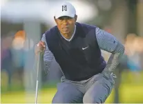  ?? RYAN KANG/ASSOCIATED PRESS ?? Tiger Woods reads the green before putting on the 12th hole for a birdie Saturday at the Genesis Open at Riviera Country Club in the Pacific Palisades area of Los Angeles. Woods remained seven shots behind the leader, Justin Thomas.