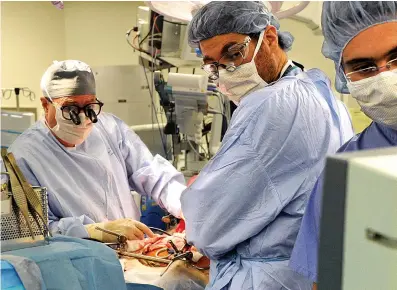  ?? Associated Press ?? ABOVE:
Columbia University
Medical Center Transplant Services surgeons watch a monitor as they perform a liver transplant at New York Presbyteri­an Hospital in New York.
Long-delayed rules that will more broadly share scarce donated livers went into effect Tuesday. The aim is to make the wait for livers, and eventually all organs, less dependent
on your ZIP code.