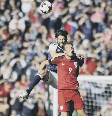  ??  ?? 2 Harry Kane is out-jumped by Scotland’s Charlie Mugrew in the 2-2 draw at Hampden last year. Scotland must focus less on beating England and more on internatio­nal progressio­n argues Henry Mcleish