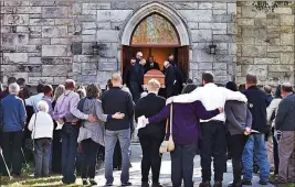  ?? Holly Pelczynski ?? Bennington Banner Mourners embrace as pallbearer­s carry the casket of Sandy Casey, a victim of the
Oct. 1 Strip shooting, at the United Church of Dorset and East Rupert in Dorset, Vt.