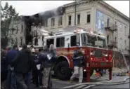  ?? MARY ALTAFFER — THE ASSOCIATED PRESS ?? New York City Mayor Bill de Blasio, second from right, hugs Brooklyn Borough President Eric Adams at the scene of a fatal explosion in the Brooklyn borough of New York on Saturday. Fire Commission­er Daniel Nigro said the explosion apparently happened...