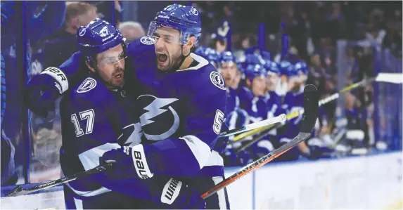 ?? GETTY IMAGES/FILES ?? Former Tampa Bay Lightning defenceman Dan Girardi, right, has delivered his last on-ice hug to Alex Killorn after Girardi announced his retirement from the NHL Friday.
