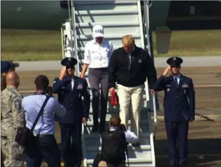  ?? THE ASSOCIATED PRESS ?? President Donald Trump and first lady Melania Trump arrive in Florida on Monday to survey damage in the state as well in Georgia from Hurricane Michael.