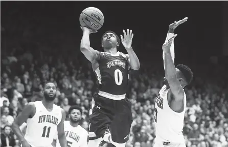  ?? THE ASSOCIATED PRESS ?? Junior Robinson (0) of Mount St. Mary’s shoots against New Orleans’ Nate Frye (3) in the second half of a First Four game of the NCAA tournament on Tuesday in Dayton, Ohio. Mount St. Mary’s won 67-66.