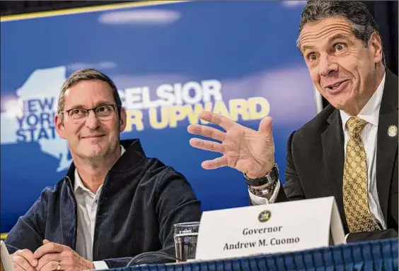  ?? Drew Angerer / Getty Images ?? John Schoettler, vice president for Global Real Estate at Amazon, looks on as then-gov. Andrew Cuomo speaks during a November 2018 news conference to discuss Amazon's decision to bring a new corporate location to Long Island City in Queens.